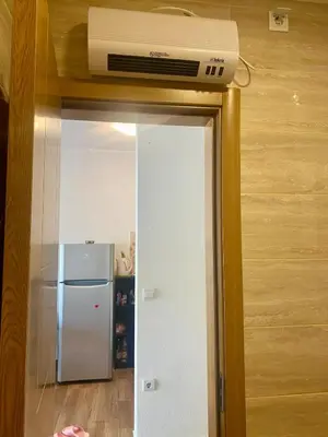 a room with a refrigerator and a air conditioner at Wonder home in Sutomore