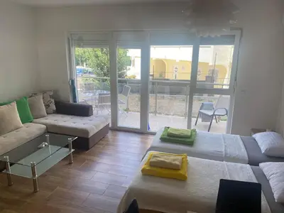 a living room with two beds and a couch at Wonder home in Sutomore