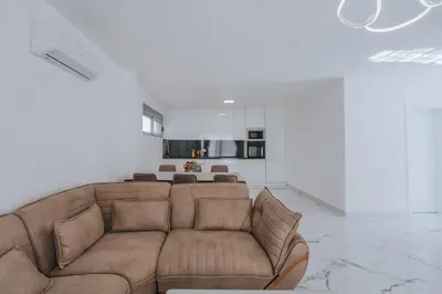 a living room with a couch and a kitchen at Villa Anida in Ulcinj