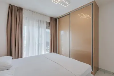a bedroom with a white bed and a window at Villa Anida in Ulcinj