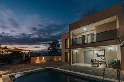 a house with a swimming pool at night at Villa Anida in Ulcinj
