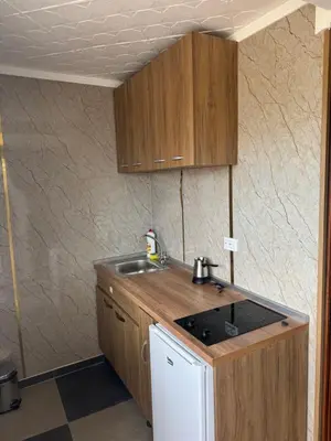a kitchen with a sink and a counter top at M&P FlyInn in Podgorica