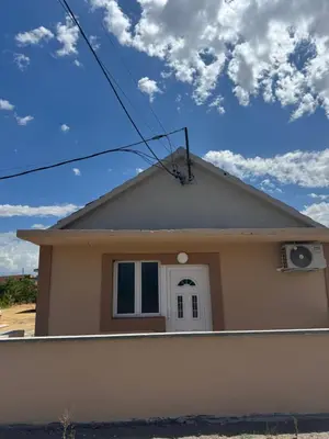 a house with a blue sky and clouds at M&P FlyInn in Podgorica