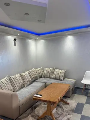a living room with a couch and a table at M&P FlyInn in Podgorica