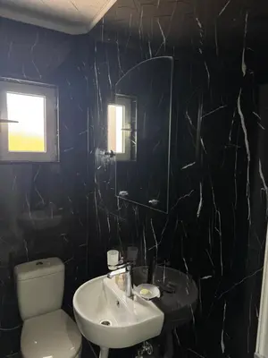 a bathroom with a sink and a toilet and a mirror at M&P FlyInn in Podgorica