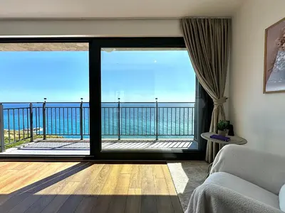 a living room with a view of the ocean at Seaview Retreat Reževići in Reževići