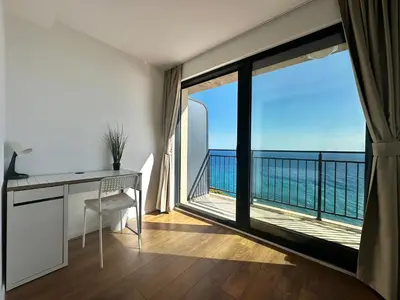 a room with a desk and a large window with a view at Seaview Retreat Reževići in Reževići