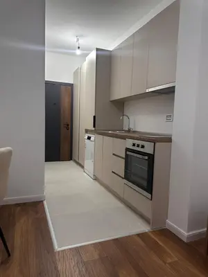 a kitchen with white cabinets and a stove top oven at Apartment LM lux in Ulcinj