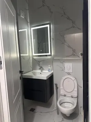 a bathroom with a toilet and a sink and a mirror at Apartment LM lux in Ulcinj