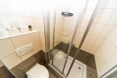 a bathroom with a shower and a toilet at Premium City Kvart Apartment in Podgorica