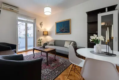 a living room with a couch and a table at Downtown Apartment Freedom in Podgorica