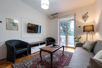 a living room with a couch and a table at Downtown Apartment Freedom in Podgorica