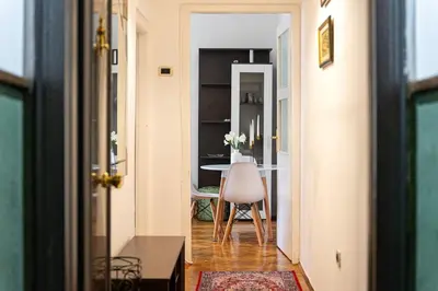 a hallway with a table and a chair in a room at Downtown Apartment Freedom in Podgorica