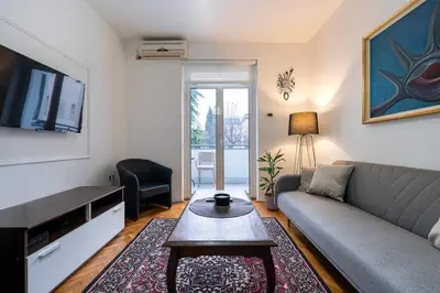 a living room with a couch and a tv at Downtown Apartment Freedom in Podgorica
