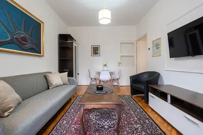a living room with a couch and a table at Downtown Apartment Freedom in Podgorica