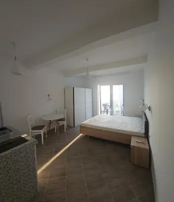 a bedroom with a bed and a table in it at Hotel Kunjui in Utjeha