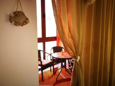 a table and chair in a room with a window at Gerbera Budva Montenegro in Budva