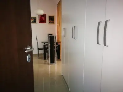 a hallway with two white doors and a table at Gerbera Budva Montenegro in Budva