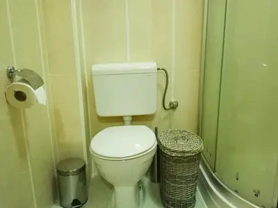 a bathroom with a toilet and a trash can at Gerbera Budva Montenegro in Budva