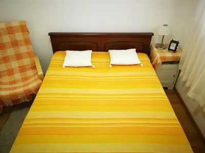a bed with two pillows on it in a room at Gerbera Budva Montenegro in Budva