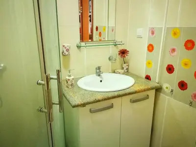 a bathroom with a sink and a mirror at Gerbera Budva Montenegro in Budva