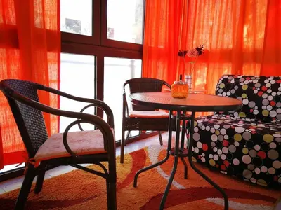 a living room with a table and chairs and a couch at Gerbera Budva Montenegro in Budva
