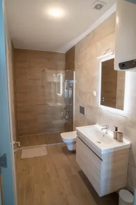 a bathroom with a sink and a shower and a toilet at FAVEHOME Apartment Sea View Pool Parking 2 Bedrooms Near Beach in Bar