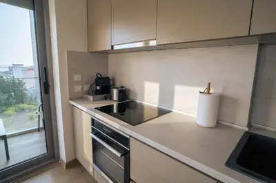 a kitchen with a stove and a sink and a window at FAVEHOME Apartment Sea View Pool Parking 2 Bedrooms Near Beach in Bar