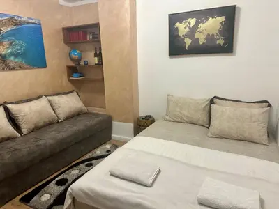 a living room with a bed and a couch at Dasic apartments 2 in Podgorica