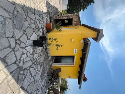 a yellow house on the side of a building at Apartmani Jana in Sutomore