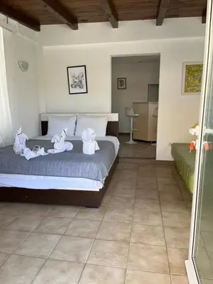 a bedroom with a bed with towels on it at Apartmani Jana in Sutomore