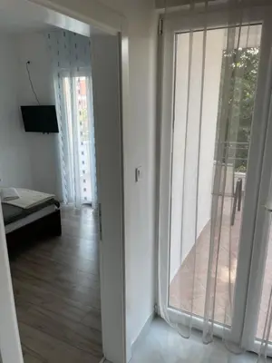 a room with a sliding glass door to a balcony at Apartments Revea in Budva
