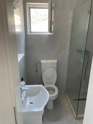 a bathroom with a toilet and a sink and a shower at Apartments Revea in Budva