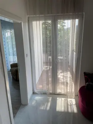 a living room with a sliding glass door to a patio at Apartments Revea in Budva