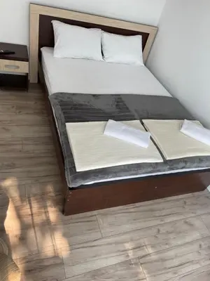 a bed with two pillows on it in a room at Apartments Revea in Budva