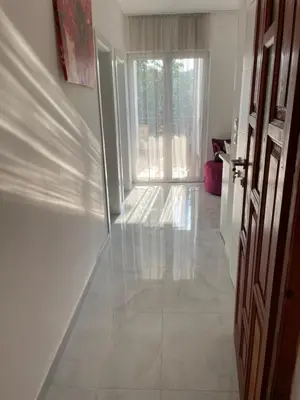 an empty hallway with a door and a window at Apartments Revea in Budva