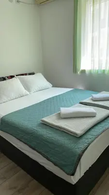 a bed with two towels sitting on top of it at Apartments Revea in Budva