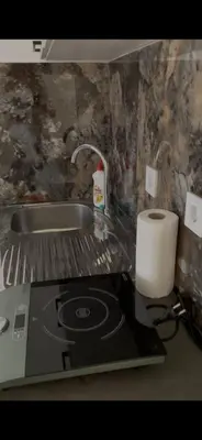 a kitchen counter with a stove and a roll of paper towels at Apartments Revea in Budva