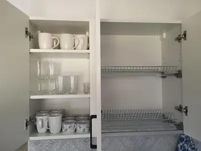 a cupboard filled with lots of cups and glasses at House Kona in Zupci