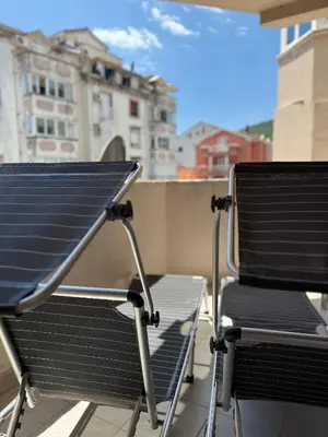 two chairs sitting on top of a balcony at Coral apartment in Budva