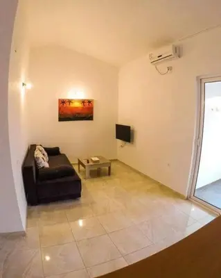 a living room with a couch and a tv at Konak in Donji Štoj