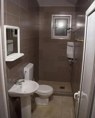 a bathroom with a toilet and a sink at Konak in Donji Štoj