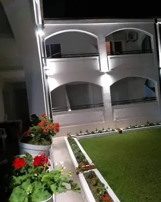 a balcony with flowers and plants in a building at Konak in Donji Štoj