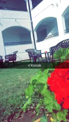 a picture of a patio with two chairs and flowers at Konak in Donji Štoj