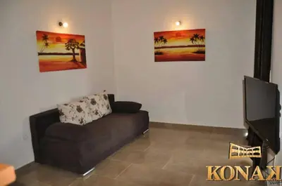 a living room with a couch and a flat screen tv at Konak in Donji Štoj