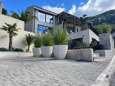 a large house with some plants in front of it at Vila panorama in Budva