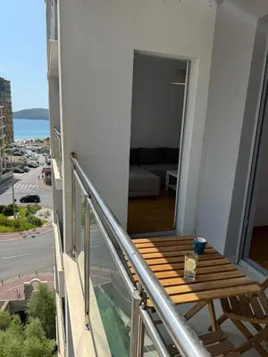 a balcony with a wooden bench on a building at Mediterano apartment Becici in Budva