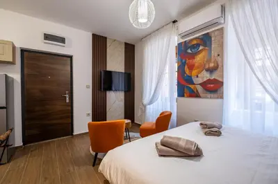 a bedroom with a bed and a painting on the wall at Apartman Ksenija in Cetinje