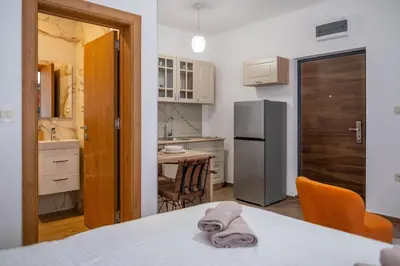 a kitchen with a table with a towel on it at Apartman Ksenija in Cetinje