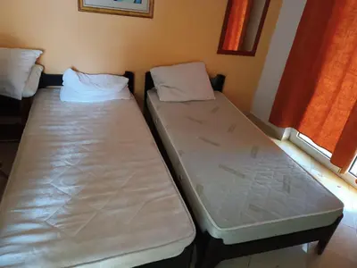 two beds sitting next to each other in a room at Budva obala in Budva